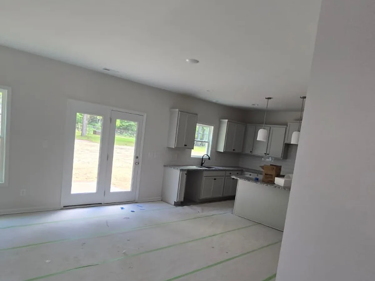 Open kitchen and living area painted before the floors go in