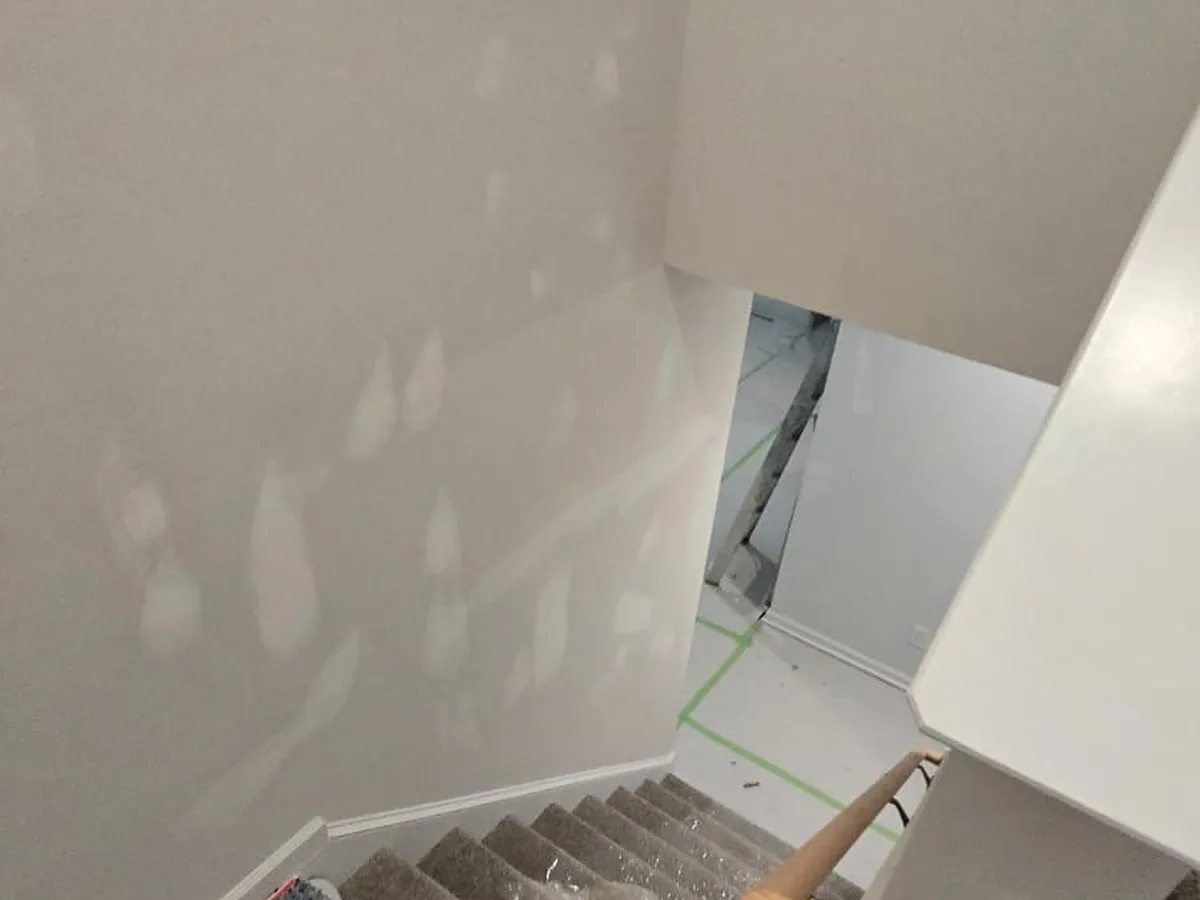 Stairwell walls prepped and painted with the stairs still bare